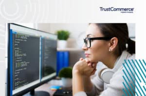 Woman staring at a coding on a computer screen