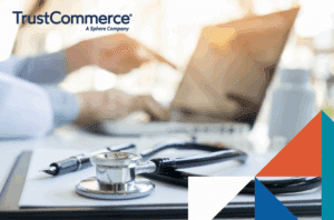 Healthcare worker using a computer with a stethoscope by their side